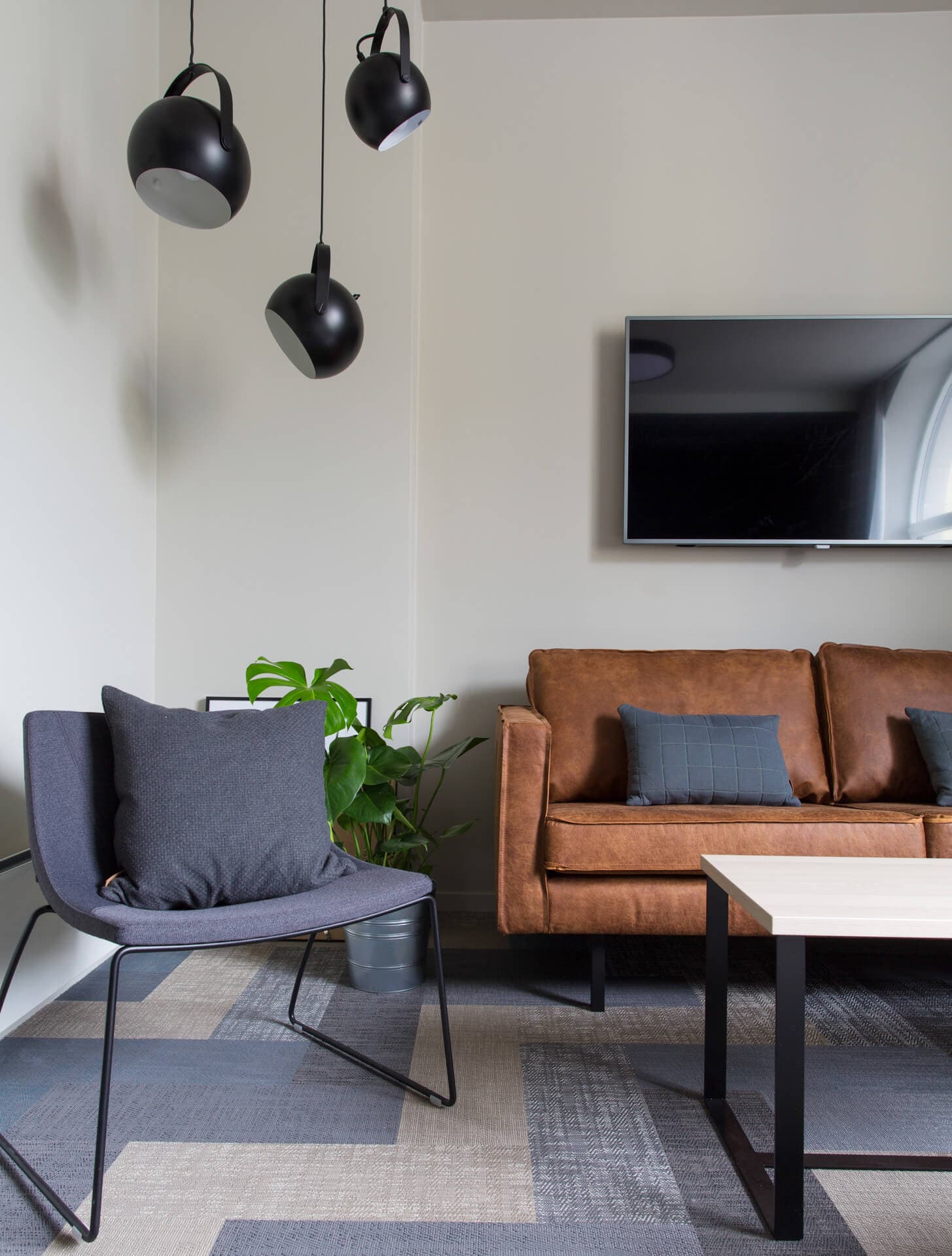 Seating area, sofa, chair, tv and a table