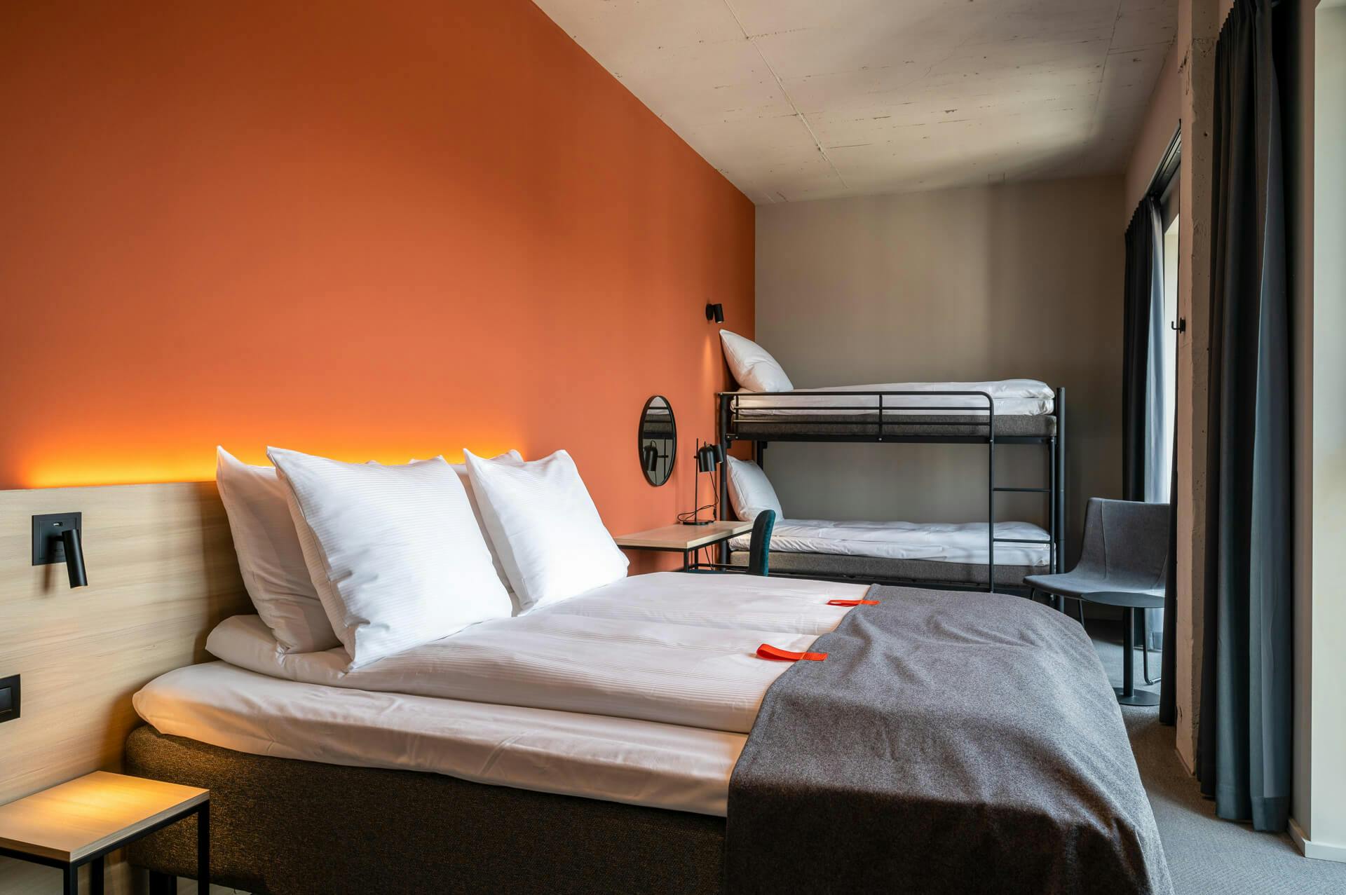 Double bed, bunk bed, chair, orange wall