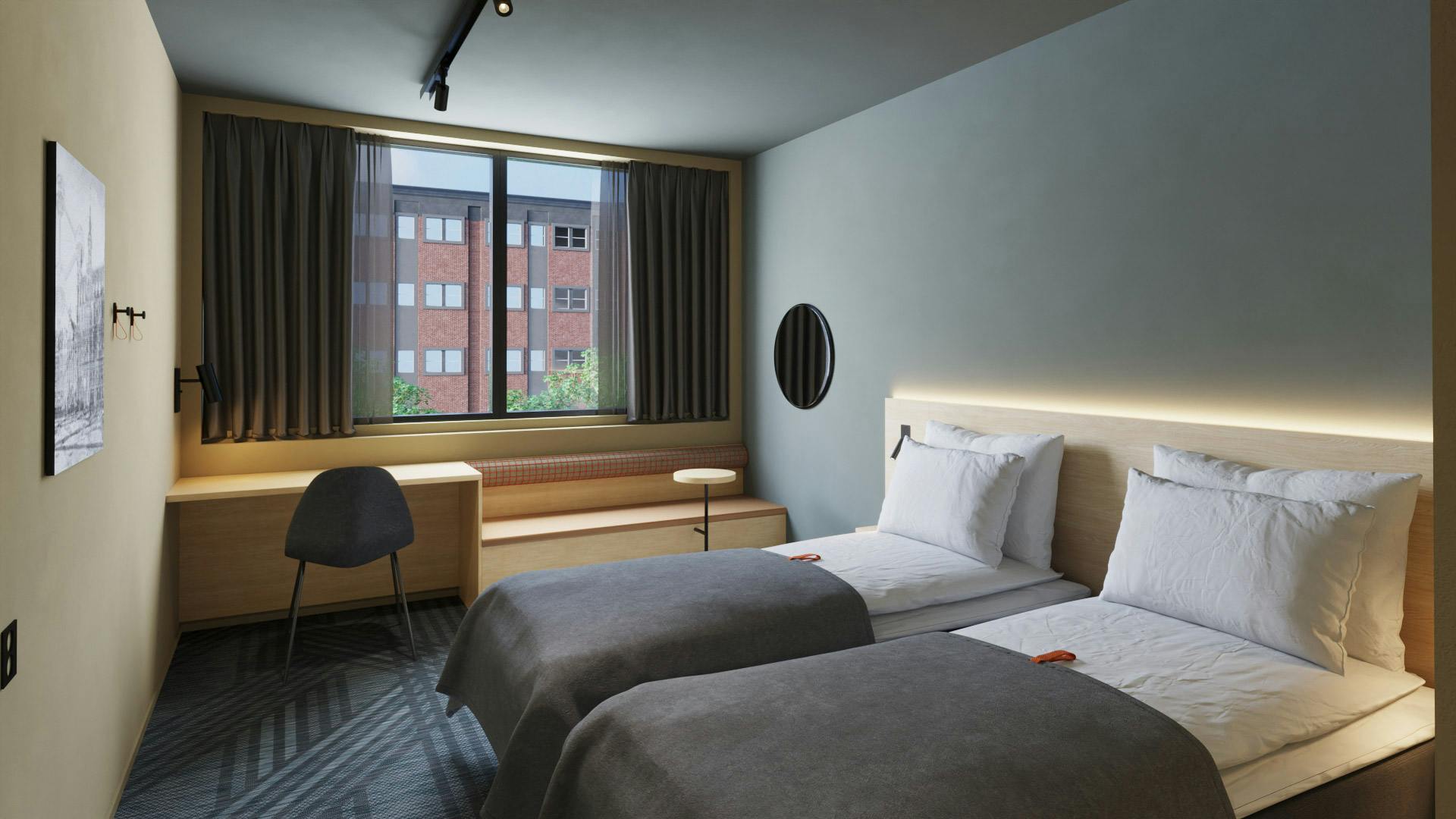 Twin room in Cirybox Brussels. Two single beds, seating area with window.