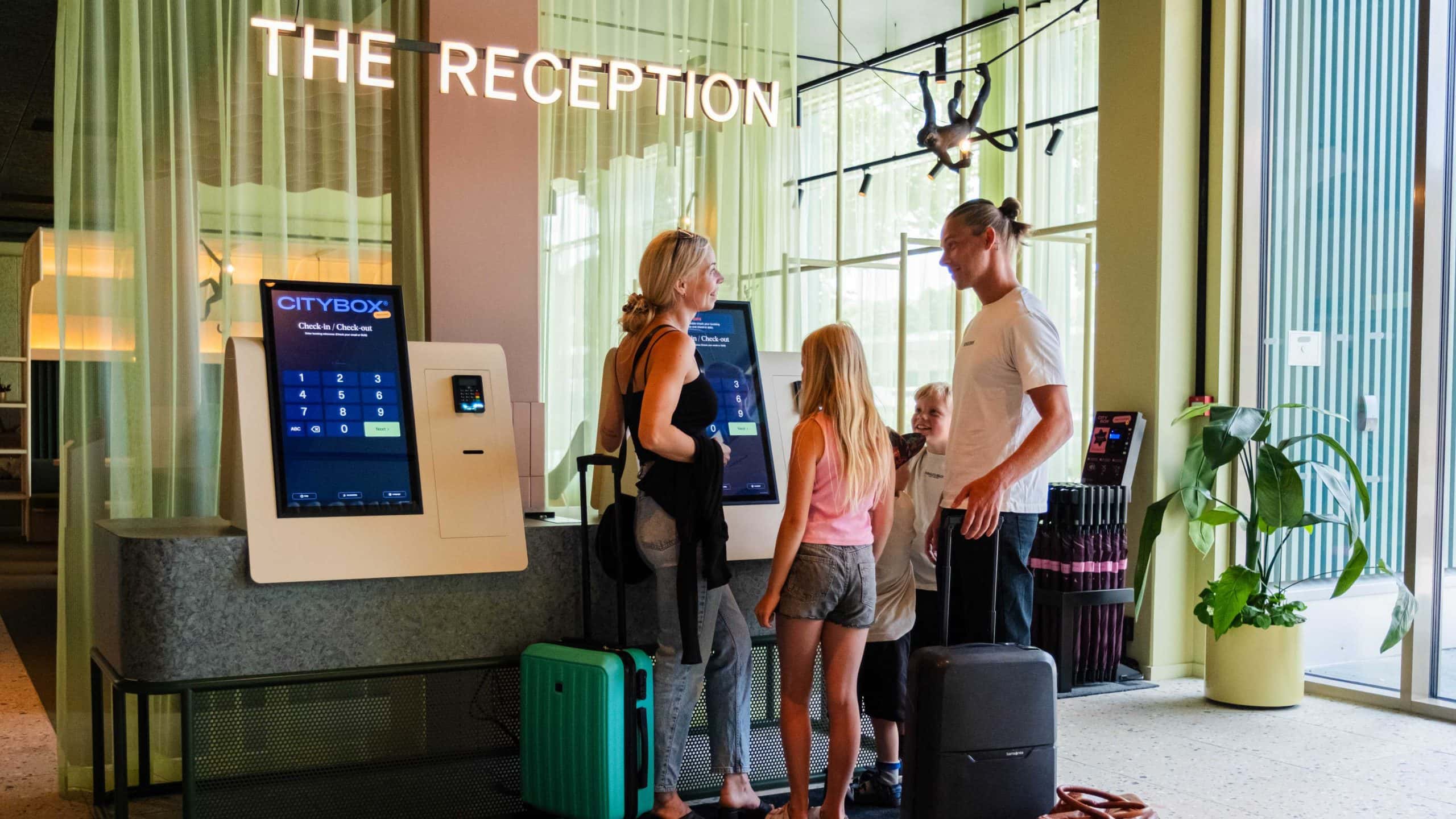 Family standing in the reception at Citybox Kristiansand