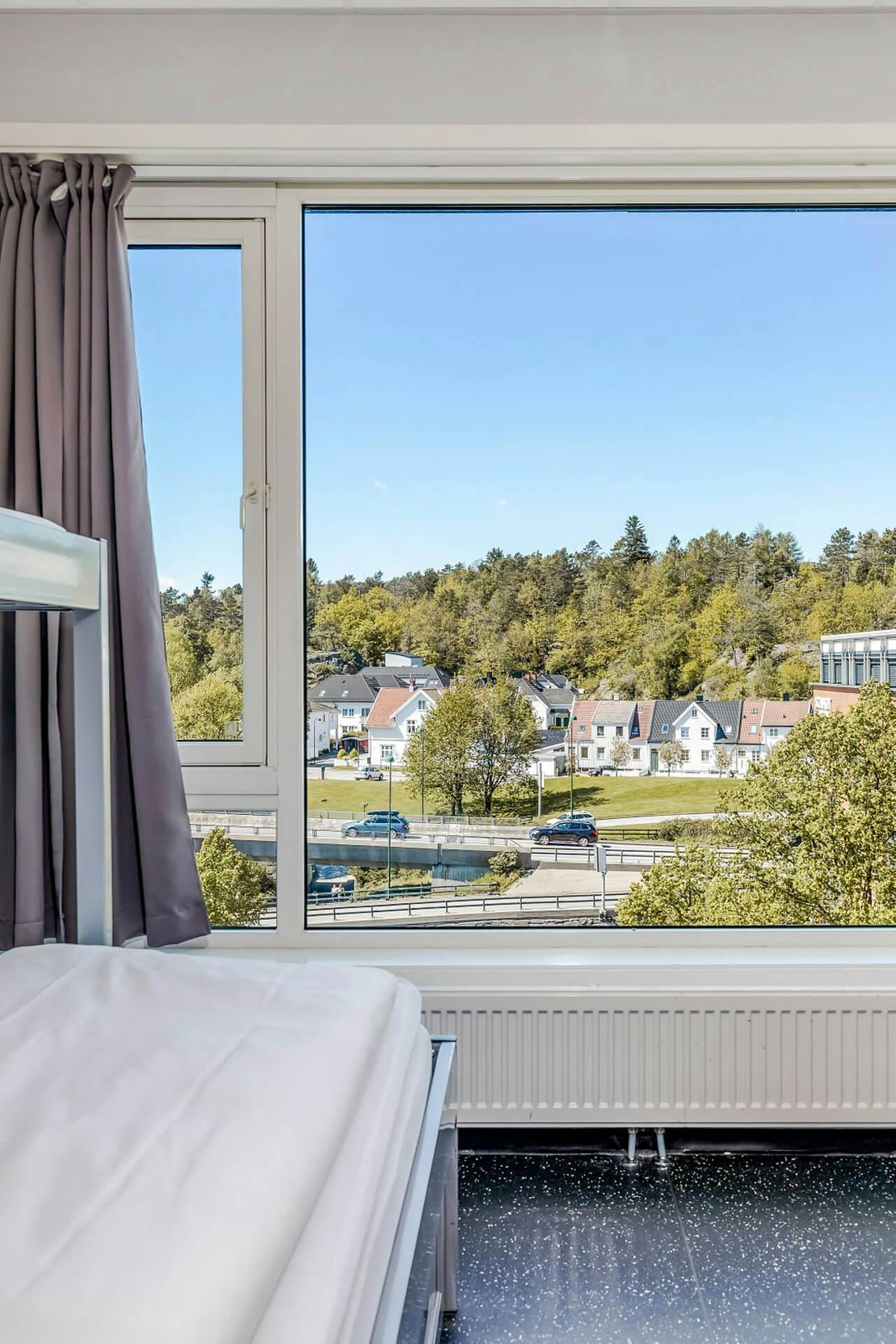 Bunk bed, view of Kristiansand, curtains, white wall